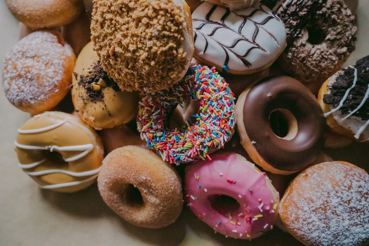 Assortment of fresh glazed and sprinkled donuts